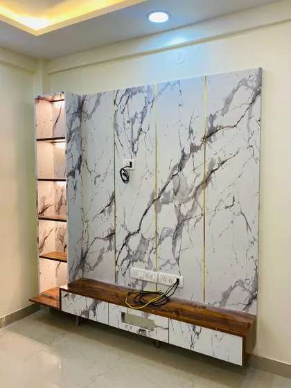 A full view of the marble-laminate TV unit, showing its scale and modern aesthetic before the television is mounted.