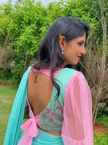 A look at the back of the modern blouse design. It features a low-cut back with a tie-up bow and subtle floral embroidery, adding a unique and personal element.