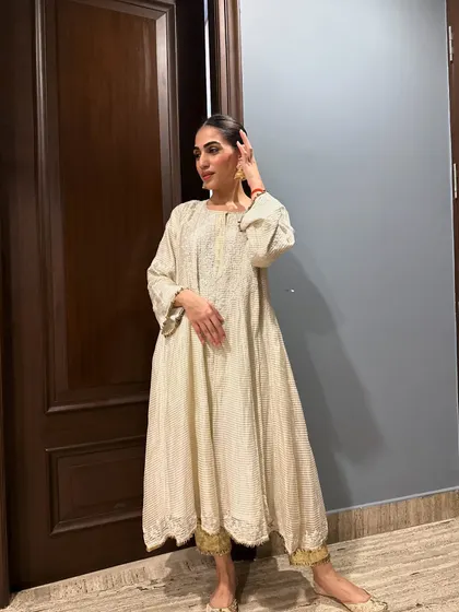 A candid pose in the anarkali, showing the flow and movement of the fabric.