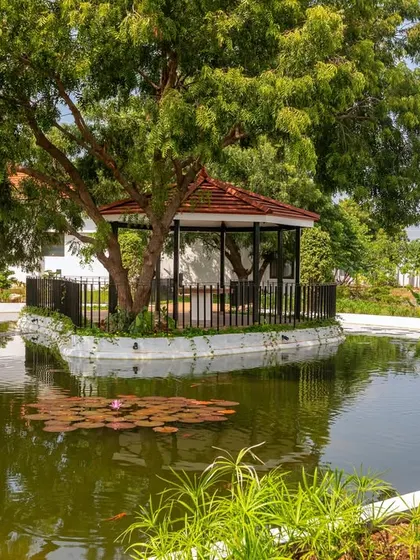 The gazebo, situated in the middle of the pond, offers a secluded and serene seating area to connect with nature and enjoy the tranquility of the water.
