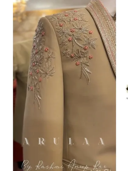 A close-up of the shoulder embroidery on the beige tuxedo. I used a mix of silver thread and subtle pink accents to create a sophisticated floral pattern that is both unique and timeless.