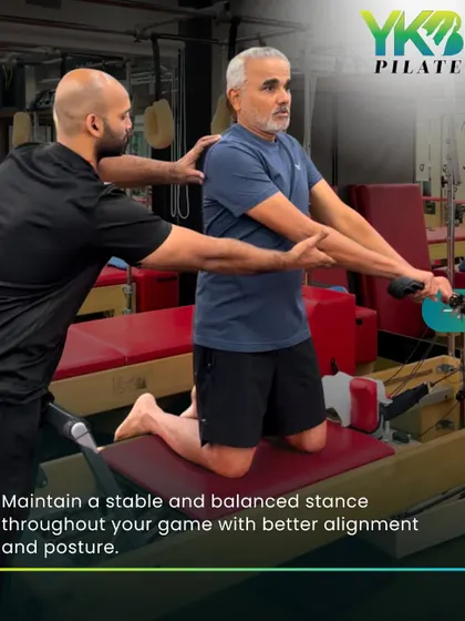 A trainer provides hands-on assistance to an older client on the reformer. This personalized guidance ensures proper form, maximizes benefits, and maintains stability throughout the workout.