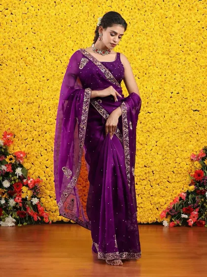 The full view of the purple organza saree, a regal and sophisticated choice for an evening event.