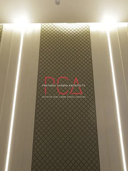 A detail shot of the textured wallpaper and integrated lighting on the living room wall of The Cursive Abode.