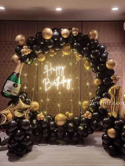 An 18th birthday celebration with a touch of class. This black and gold balloon ring is accented with a champagne bottle balloon, setting a festive mood for the new adult.