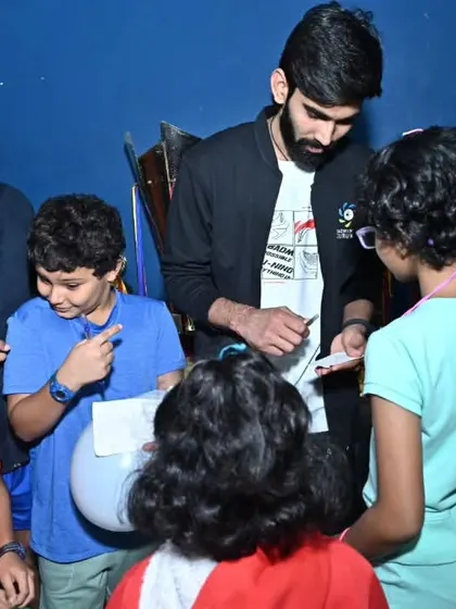 Srikanth Kidambi signing autographs for our excited young players, creating memories that will last a lifetime.
