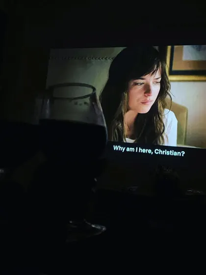 A glass of wine and a classic like 'Fifty Shades of Grey' on the big screen makes for a perfect night in.