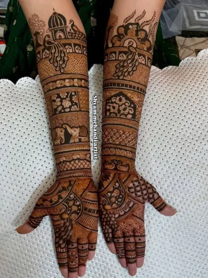 A traditional design with peacocks, elephants, and architectural domes covering the arms.