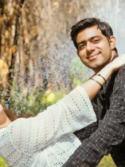 A fun, candid moment captured during an outdoor pre-wedding shoot, showing the couple's playful interaction.
