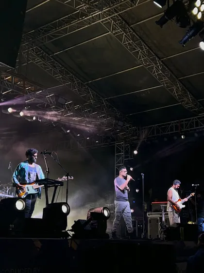 A clear shot of Sanam performing on our stage. The trussing and lighting rig above are visible, demonstrating the professional-grade setup we provide for every concert.