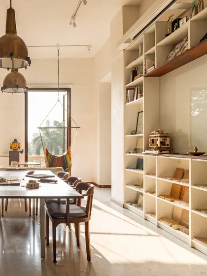 Our studio is filled with light and inspiration. A large bookshelf displays our library of architectural books and material samples, while a hammock chair by the window offers a place for quiet thought, reflecting our belief in the importance of pause and reflection.