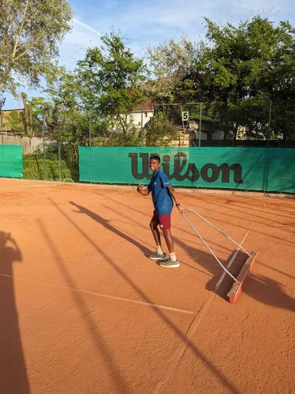 Part of being a disciplined athlete is taking care of the court. Nithin is seen here dragging the clay court after a practice session in Europe.