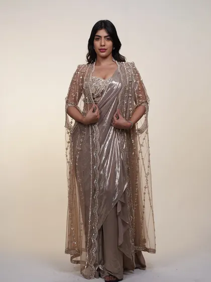 The full look of the metallic saree with its embroidered cape. This outfit is all about layers, texture, and high-fashion drama.