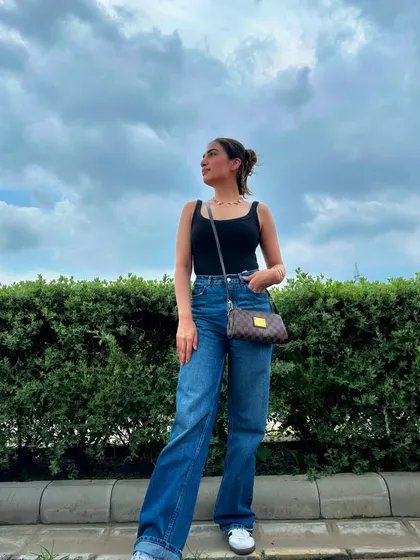 A simple, classic look: a black tank top with wide-leg blue jeans. Perfect for a day when you want to be comfortable but still look put together.