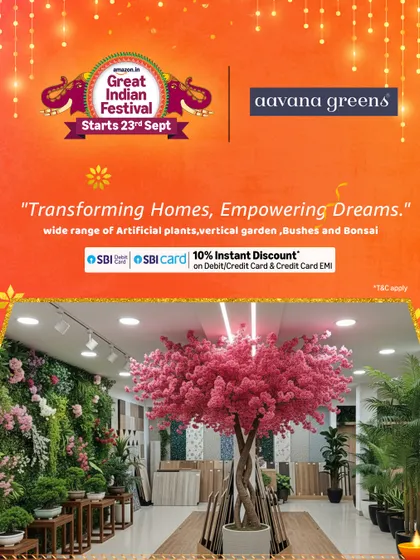 This image from our showroom features a beautiful pink flowering tree and a lush vertical garden, showcasing some of the stunning home decor you can find with us.