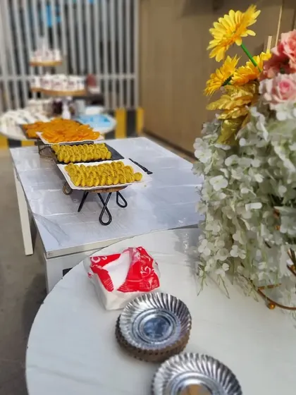 Another view of our festive dessert table for a corporate Holi event. The setup is clean, inviting, and stocked with traditional sweets to make the celebration complete.