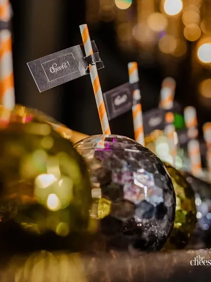 Custom cocktails served in disco ball-shaped glasses, a fun and thematic detail for a cocktail party.