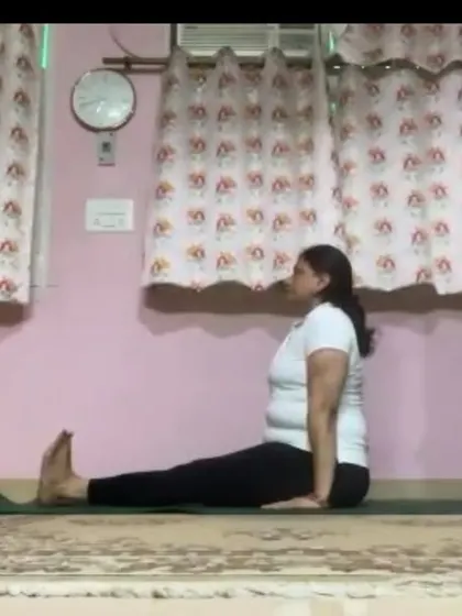 An instructor in Dandasana (Staff Pose), the foundational seated posture. We teach the importance of proper alignment in even the simplest of poses to build a strong practice.