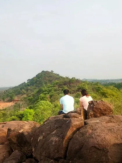 Two guests pause on a hilltop to take in the expansive view. Our location offers incredible opportunities for trekking and connecting with the vastness of nature.