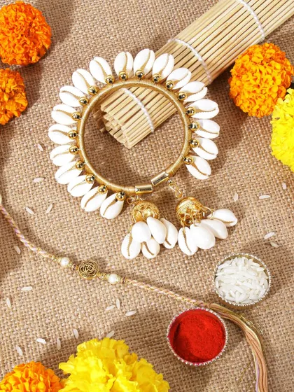 This vibrant Rakhi flatlay uses a burlap background and marigold flowers. The bright, festive colors create a joyful and traditional atmosphere, perfect for the occasion.