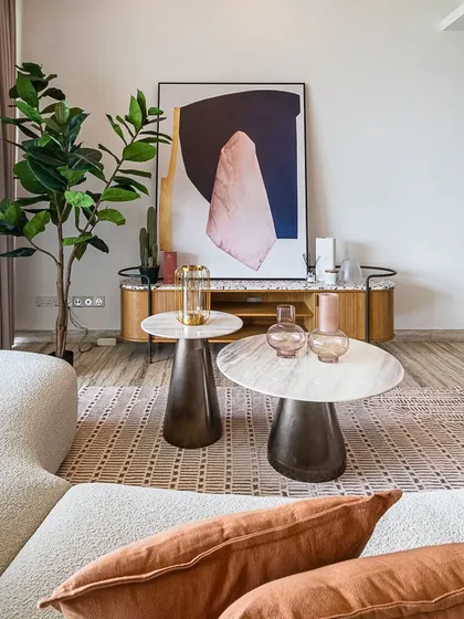 A closer look at the Cone Round Coffee Tables with their elegant marble tops, paired with the Tierra Sideboard. The combination of different materials and textures adds depth and interest, reflecting a sophisticated approach to interior design.