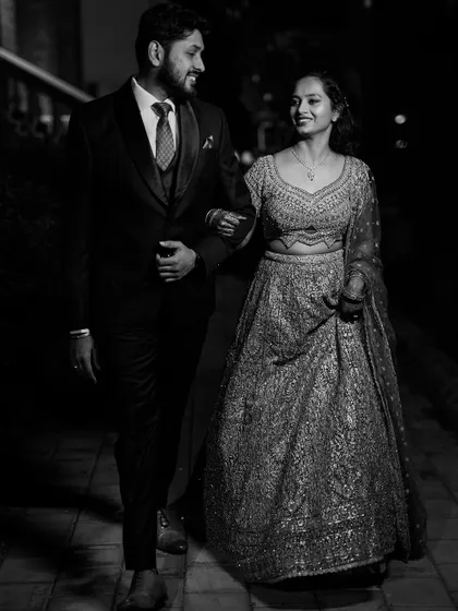 A black and white photo capturing a candid moment between the couple during their reception. These unposed shots often become the most cherished memories.
