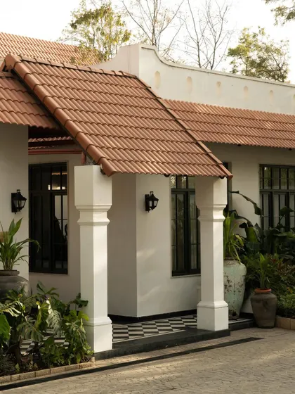 The exterior of Elgin Cafe, where the clean lines of the building meet the organic forms of the landscape. The design reinterprets colonial verandahs and columns with a minimalist, contemporary sensibility.