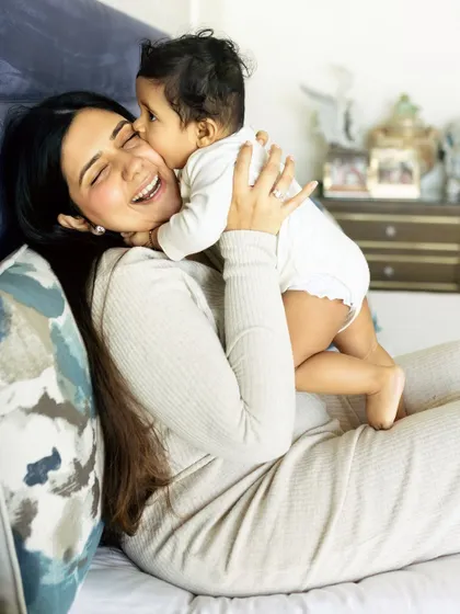 Sometimes the best moments are the simple, unposed ones at home. A candid kiss from your baby on the couch can become the most precious memory of all.