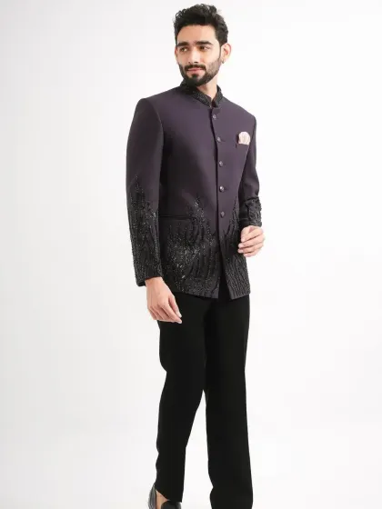 The model showcasing the fit and fall of the purple Jodhpuri suit.