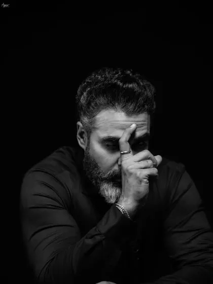 Another angle from our thoughtful series, this frame captures a pensive mood. The interplay of light and shadow across his face tells a story without a single word, a signature of my fine art portrait style.