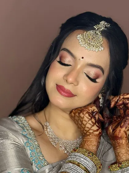 A gorgeous reception look in a silver-grey saree. I used soft pink tones on the eyes and lips to create a look that is both romantic and elegant.