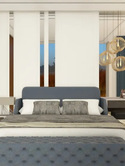 A serene and sophisticated bedroom with a deep blue color scheme. The design features tall, clean-lined wall panels behind the bed and elegant globe pendant lights, creating a calm and luxurious retreat.