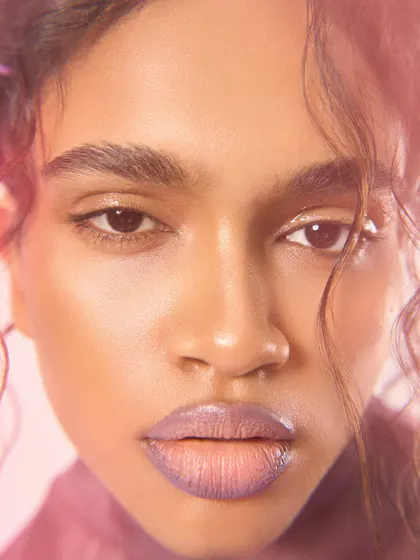 A direct, full-face beauty portrait for Ponny Mag, highlighting the model's features and the soft makeup.