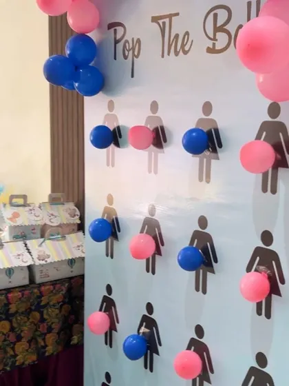 A fun "Pop the Balloon" gender reveal game set up as part of the baby shower festivities.