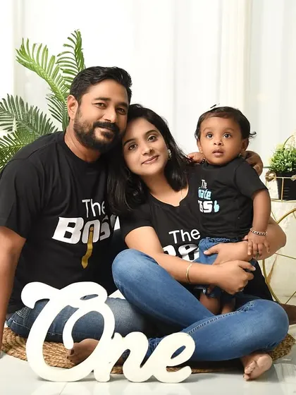 Celebrating their baby's first birthday with a family portrait. The "One" sign and boho backdrop tie the whole session together.