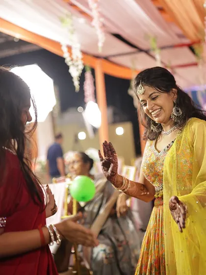 Another shot of the bride dancing, her smile and her mehendi lighting up the event.