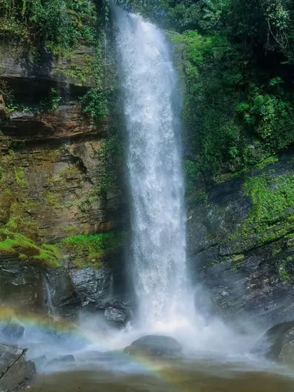 The stunning Didupe Falls, with a rainbow forming in its mist. It's a magical sight on our Charmadi ghat treks.