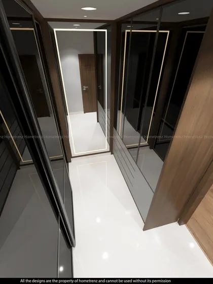 A view of a walk-in closet with dark wood and glass wardrobes, illuminated with internal LED strips.