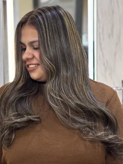 The client's happy smile after her creamy beige ash transformation. The color is soft, flattering, and modern.