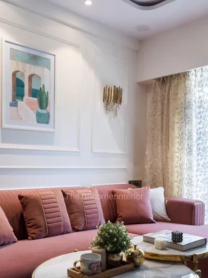 A close-up of the living room's ambiance, where the texture of the sofa, the warmth of the lighting, and the curated decor on the marble coffee table create an inviting and contemporary feel.