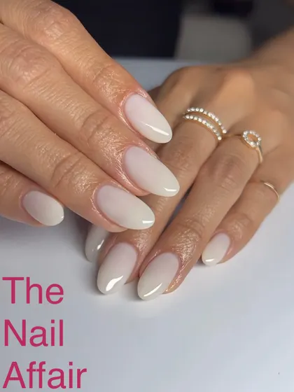 A beautiful and clean 'milky' white ombré on almond-shaped nails. This understated elegance is perfect for a modern bride.