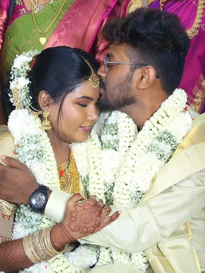 A tender hug during the Muhurtham. The groom's look is traditional and respectful, perfect for the ceremony.