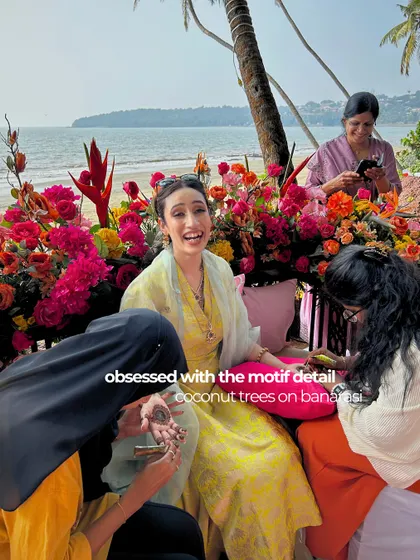 The bride's infectious laughter during her beachside mehendi. We were obsessed with the custom coconut tree motifs on her Banarasi outfit.