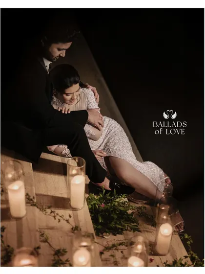 Creating a romantic and cozy atmosphere with soft, delicate lighting. The couple is surrounded by dozens of candles, casting a warm glow that is perfect for intimate reception photos.