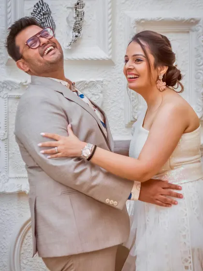 A burst of laughter. This candid shot captures the fun and relaxed atmosphere of the engagement party, showing the couple's joyful personalities.