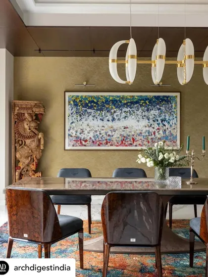 This dining room blends traditional and modern elements. A carved wooden artifact stands beside contemporary artwork, while a sleek pendant light illuminates the space. It’s a perfect example of how I integrate a client's existing treasures into a new design.
