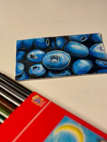A close-up of the blueberry color pencil drawing.