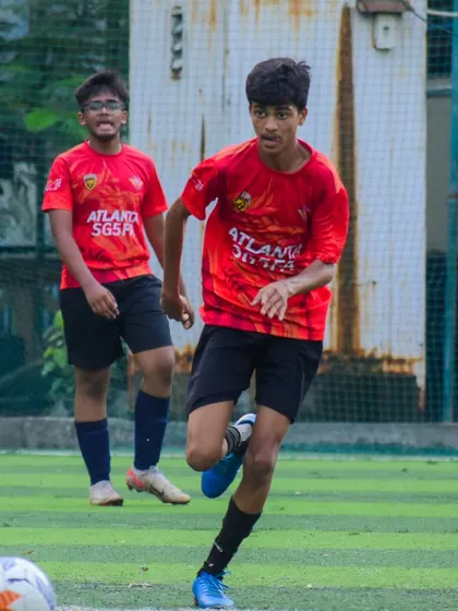 A player running with the ball, looking for an opening in the opposition's defense.
