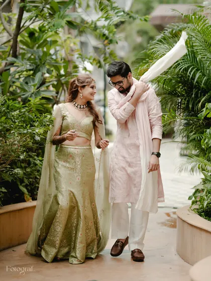 The groom playfully throws his stole over his shoulder as they walk and talk. It's these unposed, in-between moments that I love to capture.
