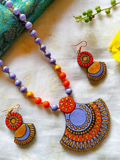 The fan-shaped pendant necklace in a lovely lavender and orange combination.